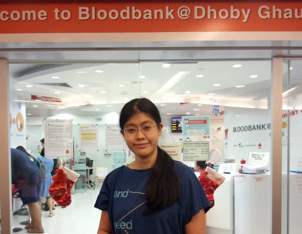 Photo of a blood donor, Jewel standing in front of Bloodbank at Dhoby Ghaut