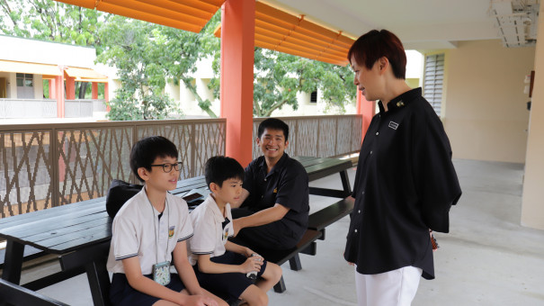 Mdm Soh Beng Mui, principal of Juying chatting with three students from her school.