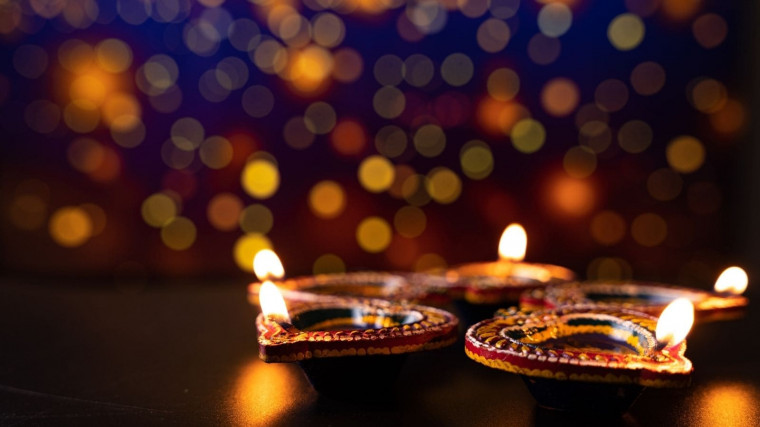Indian festival Diwali, Diya oil lamps lit on colorful rangoli. Hindu traditional. Happy Deepavali.
