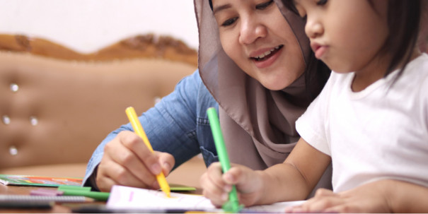 Asian muslim mother drawing with her daughter, single mom teaching baby girl, happy family concept 