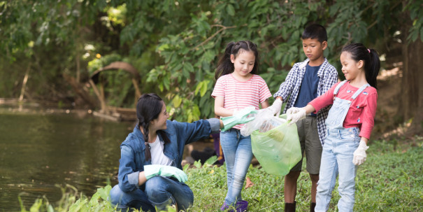 asian women and children volunteer help garbage collection charity environment river area. Group of kids school volunteer. Everyone has to help preserve the ecology on earth. (Environment concept)