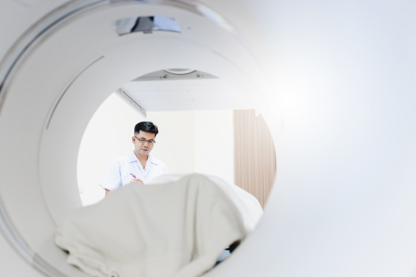 Asian radiologist to control and adjust ct scanner