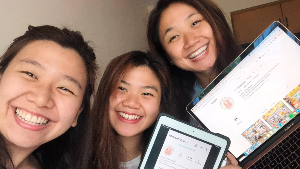 Bright smiling women holding digital devices showcasing Singapore Foodie blog, celebrating kindness and diversity, emphasizing the importance of community and inclusivity in Singapore.