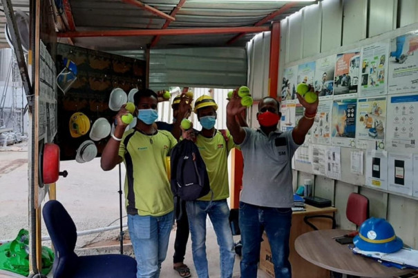 Migrant workers with the donated tennis balls