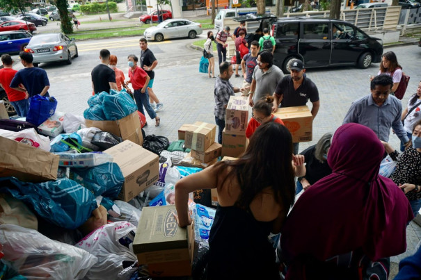Donors offloading their donated items in a pile at the donation point.