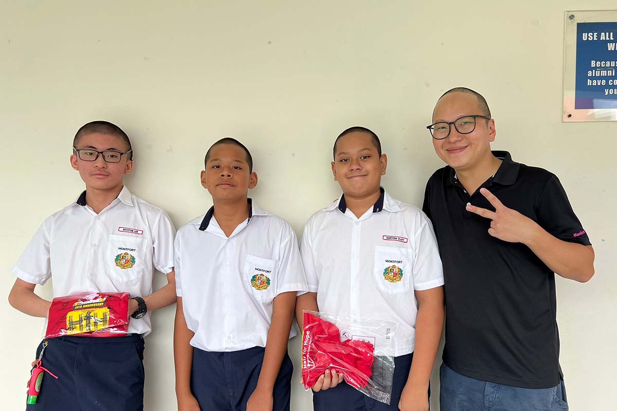 Students in school uniforms participating in the Singapore Kindness Movement Pride initiative.