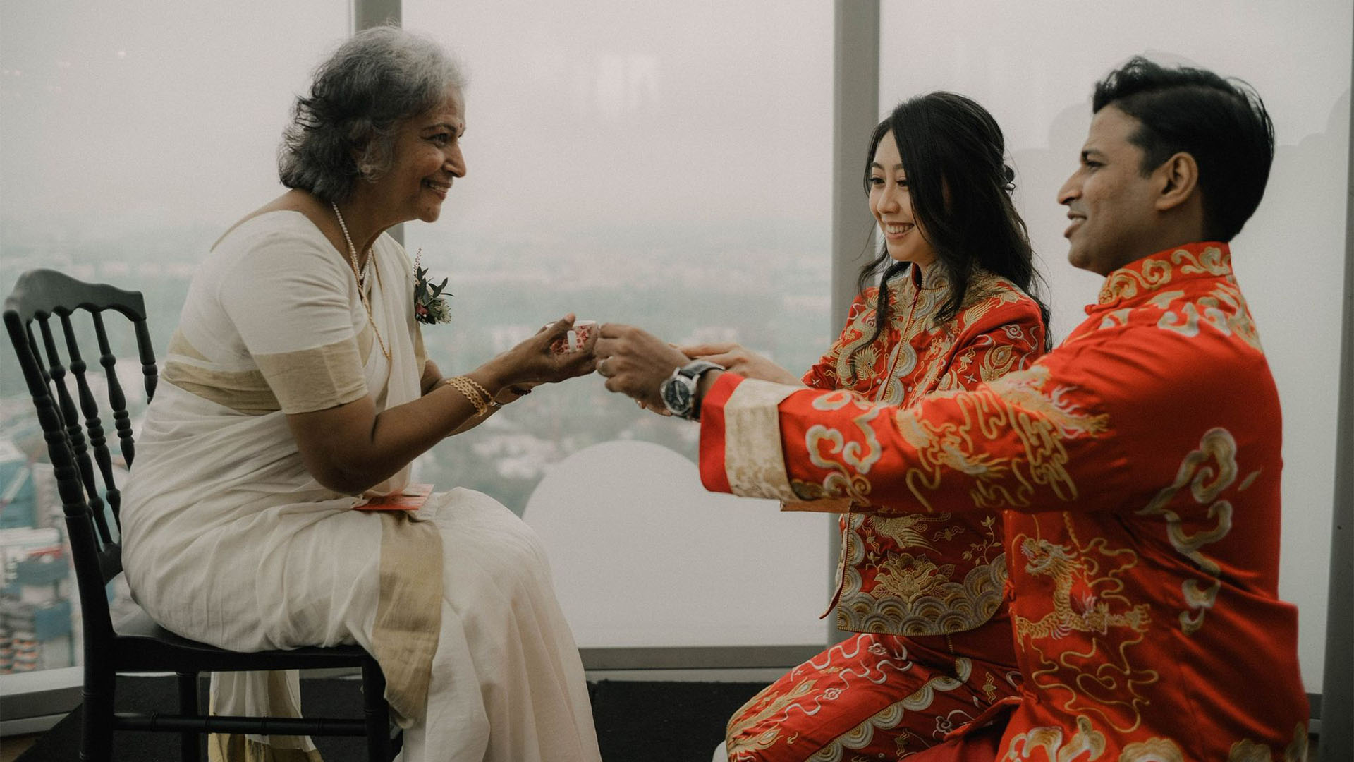 A woman receiving a traditional blessing during Singapore Pride celebration with the Singapore Kindness Movement.