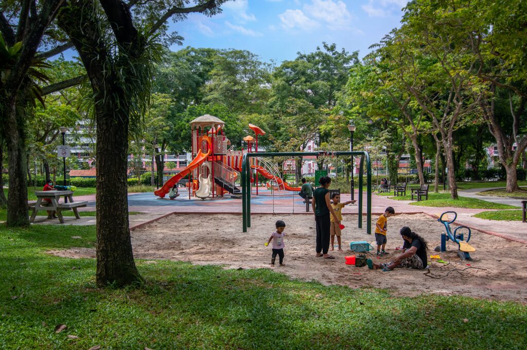 Colorful playground in a lush park promoting community and kindness in Singapore for Pride - Singapore Kindness Movement.