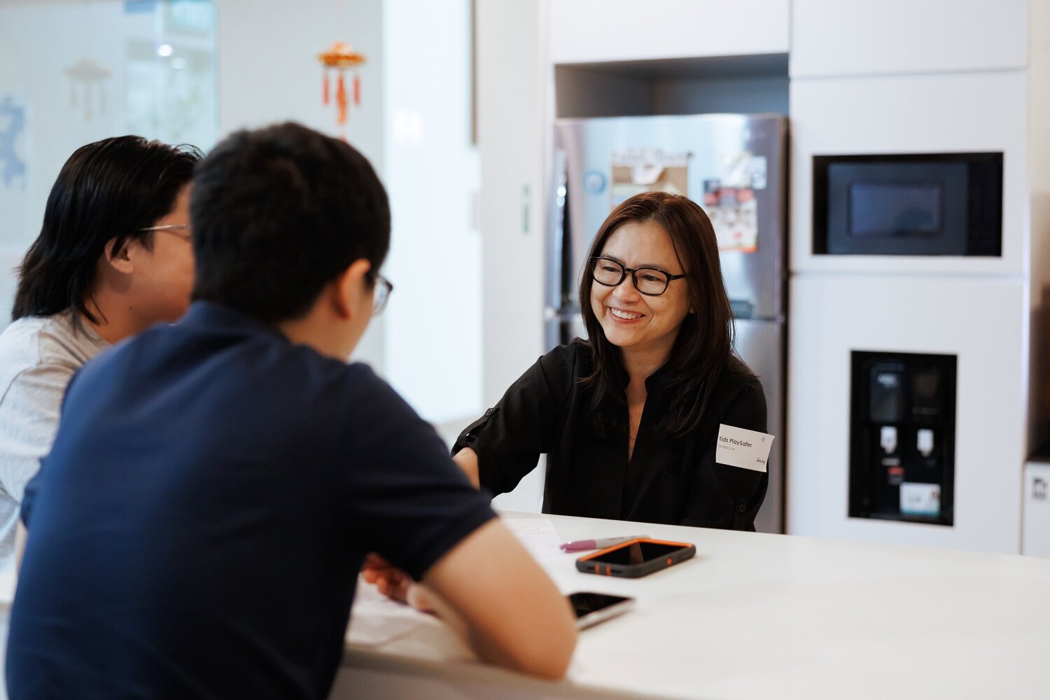 Celebrating Pride and kindness at Singapore Kindness Movement with diverse individuals engaging in a friendly conversation, promoting inclusivity and acceptance.