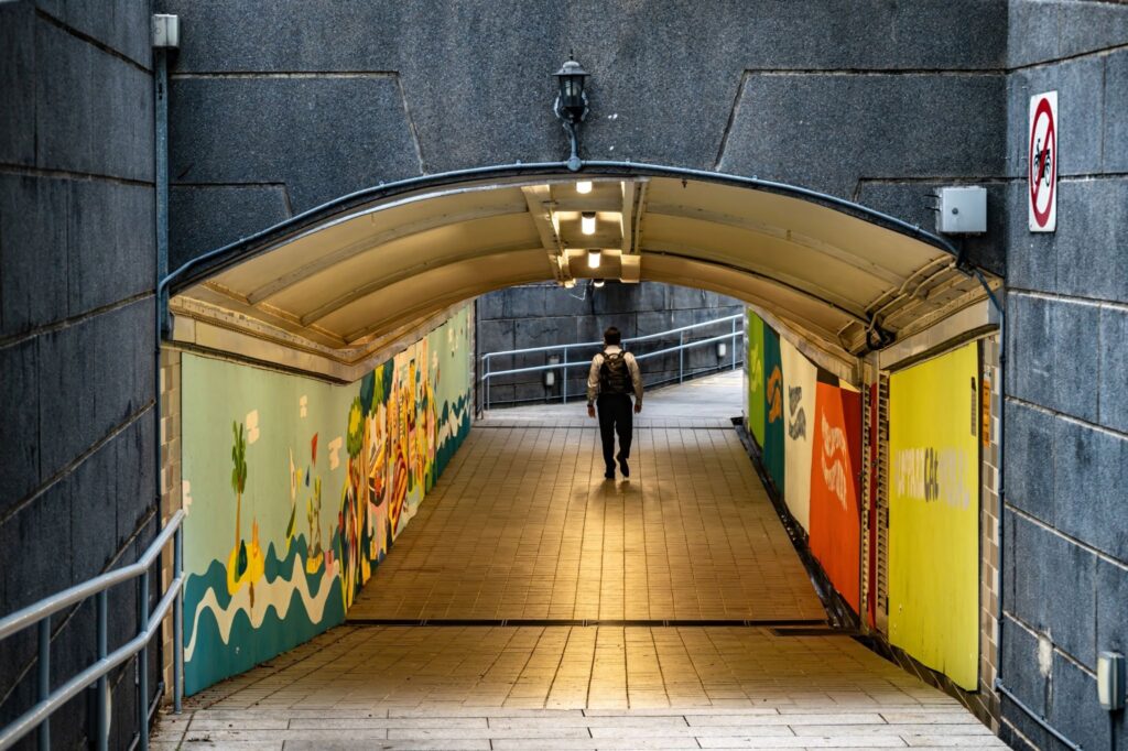 Underpass with colorful Pride-themed murals promoting kindness and inclusivity in Singapore.
